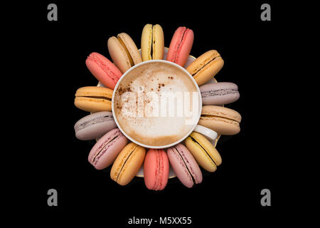 Pastel macarons around a coffee cup Stock Photo
