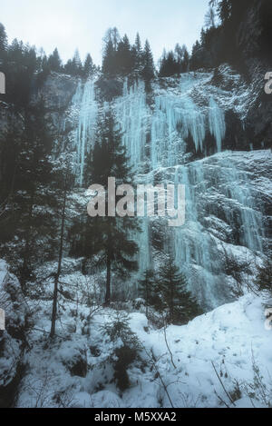 Serrai of Sottoguda, Rocca Pietore, Veneto, Belluno, Italy. An hiker admiring the frozen scenario of The Cathedral Stock Photo