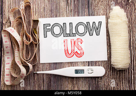 Handwritten text showing Follow Us. Business fitness health concept writing for Social Media Marketing written on wood wooden background with bandage  Stock Photo