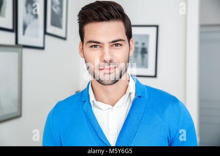 Young man patient waiting psychology session looking camera smiling Stock Photo