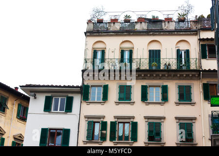 Italian house with green shutters and a balcony in Florence, Italy Stock Photo