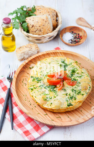 Omelet with potato from spain called tortilla de patatas on a wooden background Stock Photo