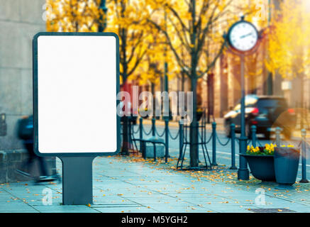 Blank vertical outdoor billboard mockup on city street on bright vibrant autumn day Stock Photo