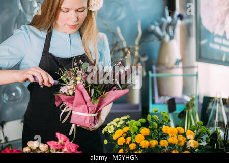 shot of nice teenager making composition from flowers indoor Stock Photo