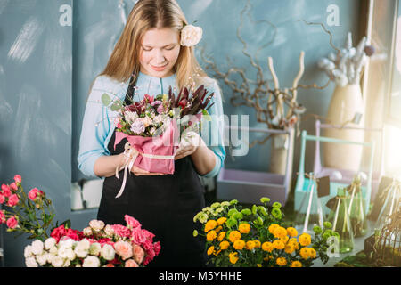 shot of teenager holding flowers indoor Stock Photo