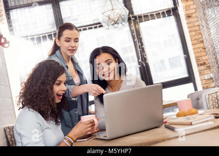 Vigorous three students having brainstorm Stock Photo