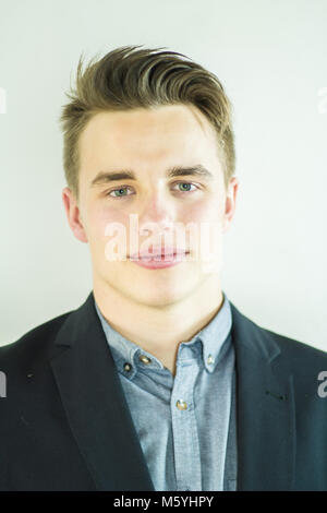 young businessman looking at camera and smiling Stock Photo