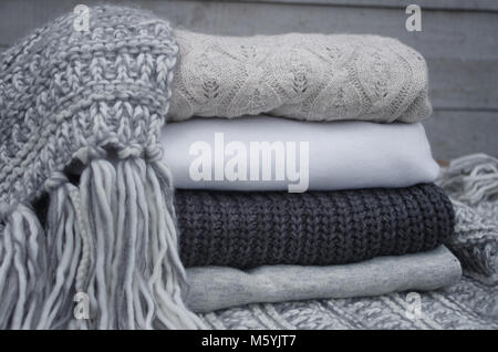 Knitted sweaters and fallen yellow leaves Stock Photo