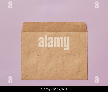 Opened brown Recycle envelope isolated on pink background Stock Photo