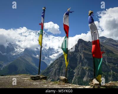 Prayer flags and Annapurna from Ghyaru village, Annapurna circuit trek, Marsyangdi river valley, Nepal Stock Photo