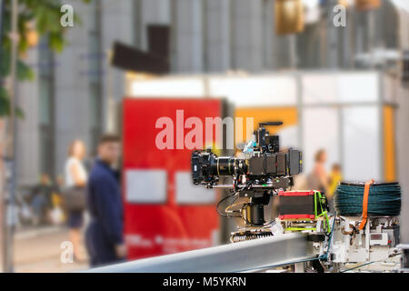 Big professional camera on rails. Outdoors movie set. Cinema pro Stock Photo