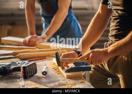 carpenter with students in woodworking workshop Stock Photo