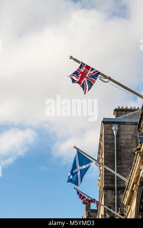 British Union Jack and Scottish Saltire on a top of City Chambers in Edinburgh, Scotland Stock Photo