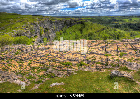 Rocky top of Malham Cove Yorkshire Dales UK popular tourist attraction in colourful hdr Stock Photo