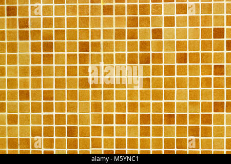 Checkered tile background pattern. Architectural mosaic detail, abstract background for bath and pool. Brown, orange, beige and ochre tiles Stock Photo