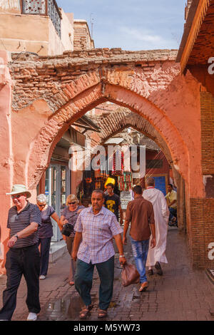 People walking through an archway in the souk, Marrakech, Morocco, North Africa Stock Photo