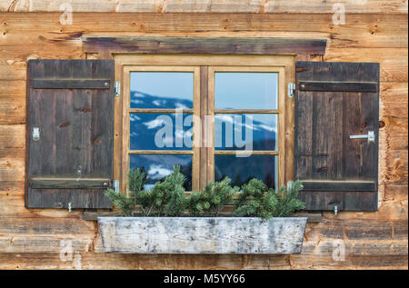 Vintage Window of old alpine house. Wooden rustic background. Stock Photo