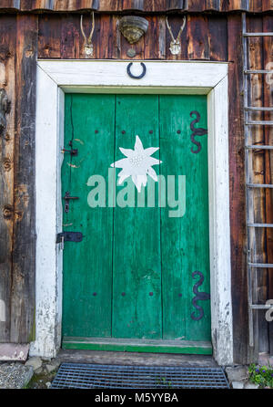 Old fashioned door of mountain hut in the Alps Stock Photo