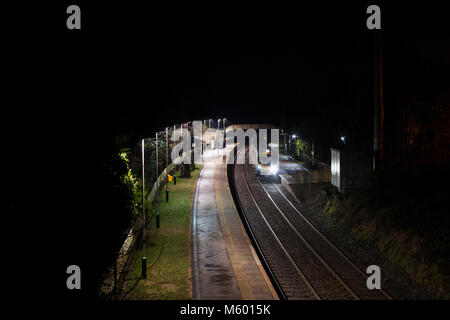 A Transpennine Express class 185, on hire to Northern Rail at Cark  station (Cumbria) on a dark night with the 1745 Preston - Barrow In Furness Stock Photo