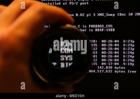 Dos on screen through magnify glass Stock Photo