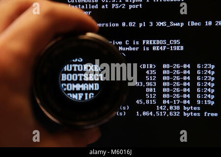 Dos on screen through magnify glass Stock Photo