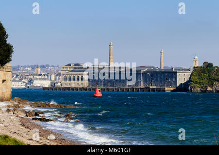 Sunlit winter view of the Royal William Yard, Plymouth, Devon, taken form the foreshore at Mt Edgcumbe, Cornwall, across the Hamoaze Stock Photo