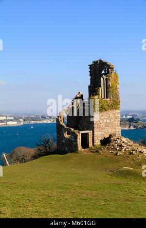 Winter sunlight illuminates a view from the folly at Mountt Edgcumbe, Cornwall, across Plymouth Sound to the Plymouth waterfront Stock Photo