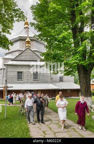 Churchgoers leaving after mass Holy Trinity Greek Catholic Church, in village of Mykulychyn, near town of Yaremche, Carpathian Mountains, Ukraine Stock Photo