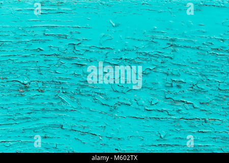 Old turquoise painted wood, weathered crackled surface background Stock Photo