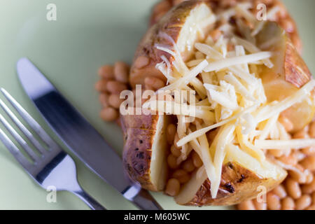 Jacket potato with baked beans and grated cheese Stock Photo