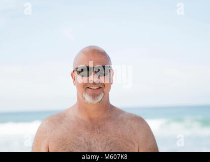 Smiling Happy Bald Man Wearing Sunglasses on the Beach in Mexico Stock Photo