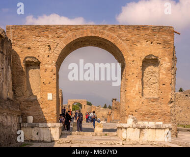Honorary arches and tourists at the Pompeii ruins, Italy. Stock Photo