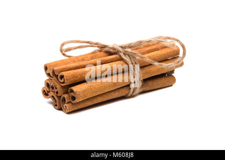 Cinnamon sticks tied with a rope, isolated on white background. Stock Photo