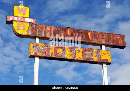 A rusting sign for a former Whiting Brothers motel stands against a blue sky in the old Route 66 community of Continental Divide, New Mexico.