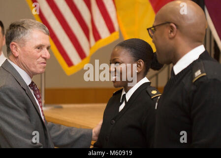 Retired Brig. Gen. William T. Bester, former chief of the Army Nurse Corps, presents coins to Maj. Jennifer Y. Givens and Capt. Marqus O. Berry, Landstuhl Regional Medical Center Clinical Nurse Educator and LRMC Registered Nurse, respectively, during the LRMC 2018 Army Nurse Corps birthday celebration, Feb. 2, 2018. Stock Photo