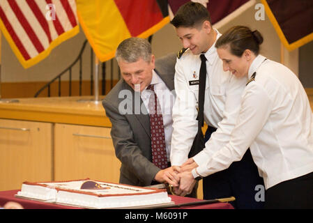 Retired Brig. Gen. William T. Bester, left, former Chief of the Army Nurse Corps, 2nd Lt. Addison, Landstuhl Regional Medical Center Staff Nurse and Col. Michelle L. Munroe, right, LRMC chief nursing officer perform the ceremonial cake cutting at the LRMC 2018 Army Nurse Corps birthday celebration Feb. 2, 2018. Stock Photo