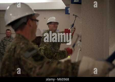 Air Commandos attend the 1st Special Operations Medical Group wall breaking ceremony at Hurlburt Field, Fla., Feb. 2, 2017. The wall breaking commenced the start of renovations in the pharmacy. (U.S. Air Force Stock Photo