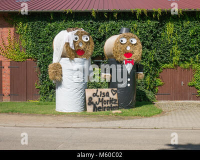 Scarecrow couple on a farm in North Germany announcing a wedding. Stock Photo