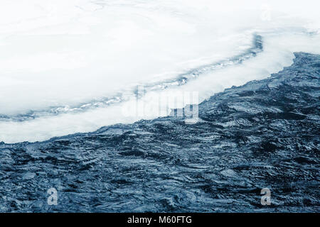 Beautiful frozen waterfall in central Norway. Winter landscape with a frozen river and ice formations. Stock Photo