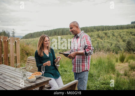 Husband and wife spending the weekend together, celebrating their anniversary with some champagne. Stock Photo