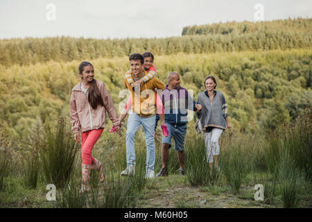 Family spending quality time together by hiking through the country side. Stock Photo