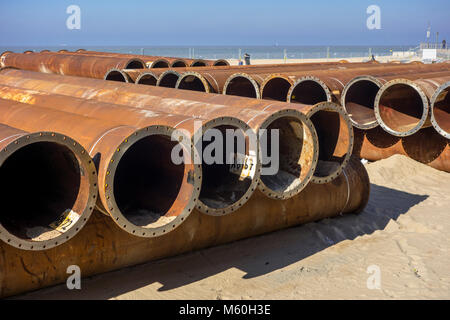 Pipeline tubes for sand replenishment / beach nourishment to make wider beaches to reduce storm damage to coastal structures Stock Photo