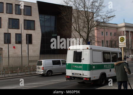 27 February 2018, Germany, Berlin: A police vehicle and a cameraman stand in front of the Turkish Embassy. So far unknown perpetrators attacked the building with paint bags in the early morning. The used colourd red, green and yellow might symbolise the Kurdish flag. Photo: Paul Zinken/dpa Stock Photo