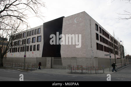 27 February 2018, Germany, Berlin.Pedestrians walk past the Turkish Embassy. So far unknown perpetrators attacked the building with paint bags in the early morning. The used colourd red, green and yellow might symbolise the Kurdish flag. Photo: Paul Zinken/dpa Stock Photo