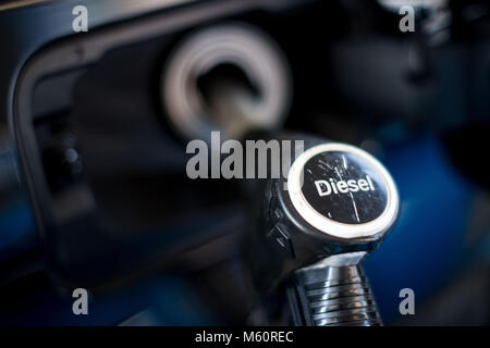 27 February 2018, Germany, Cologne: A diesel nozzle fills a car with diesel. The Federal Administrative court pronounces its judgement on the legality of diesel driving bans in citiey. Photo: Marius Becker/dpa Stock Photo