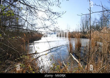 27 February 2018, Germany, Cologne: Ice covers a bay at the Pescher quarry pond. Photo: Henning Kaiser/dpa Stock Photo