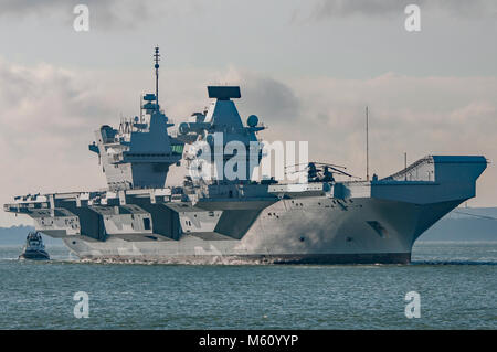 Portsmouth, UK. 27th February, 2018. HMS Queen Elizabeth being guided through The Solent on it's return from rotary flying trials. Credit: Neil Watkin / Alamy Live News Stock Photo