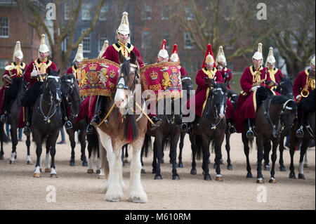 Horse Guards Parade, London, UK. 27 February 2018. The Household Cavalry Band with Drum Horses accompany Life Guards once a year to Changing the Guard ceremony, bringing along young horses to give them an experience of urban noise and bustle. Snow flurries fall during the ceremony. Credit: Malcolm Park/Alamy Live News. Stock Photo