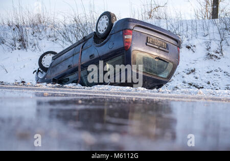 Talkau, Germany. 27th Feb, 2018. A car lies on the 24 motorway after the icy roads caused multiple collisions. Several people were injured during the accident. Photo: Daniel Bockwoldt/dpa Credit: dpa picture alliance/Alamy Live News Stock Photo