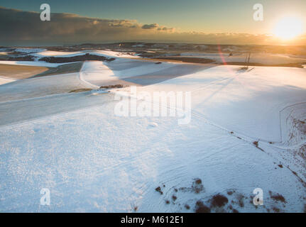 Firle, UK. 27th February 2018. Snow laying over the South Downs national park at the end of a bitterly cold day. Credit: Peter Cripps/Alamy Live News Stock Photo